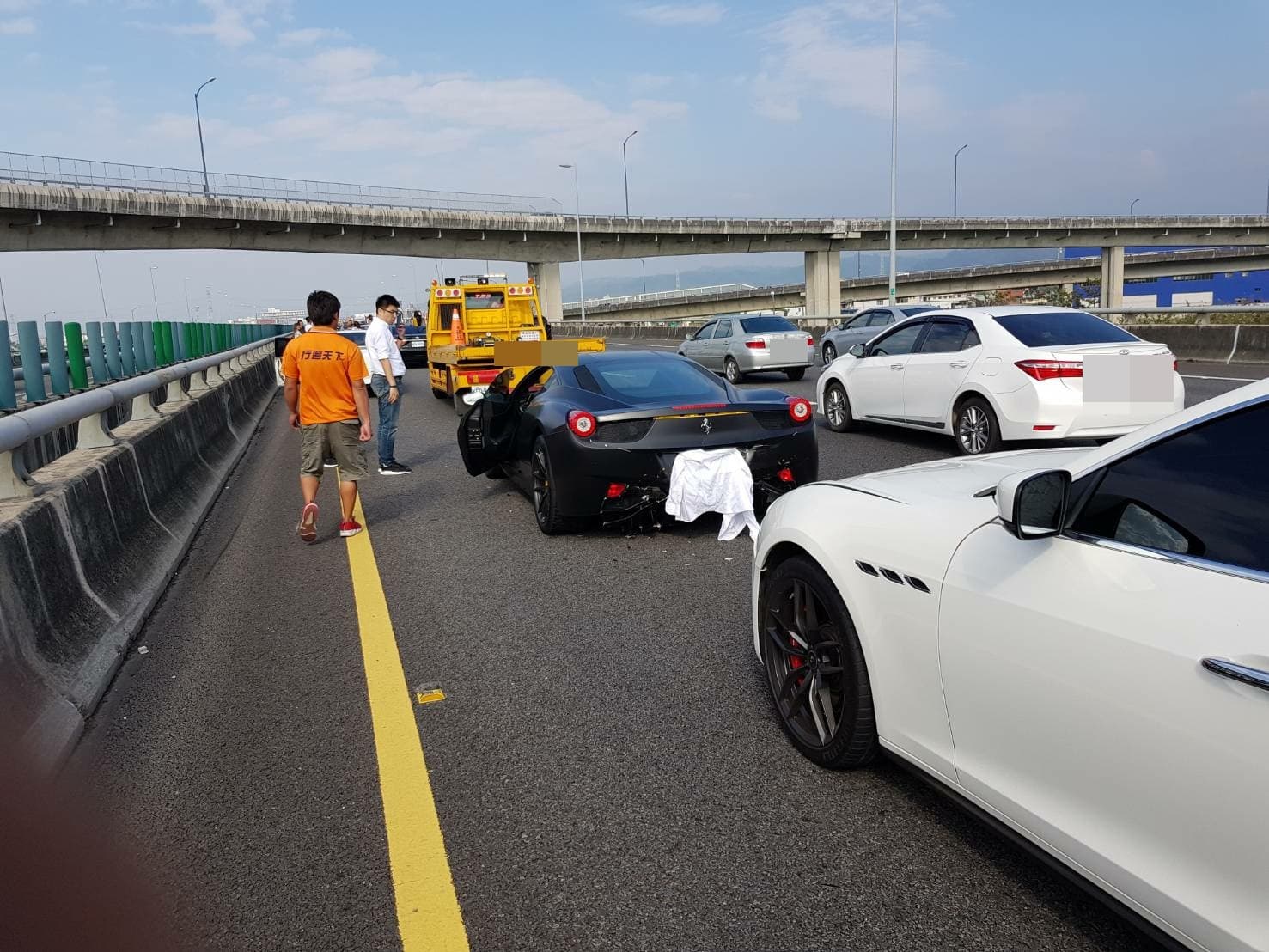 法拉利跑車也受到波及,車尾蓋著白布之處也有些微受損。(台灣新聞記者聯盟資訊平台)