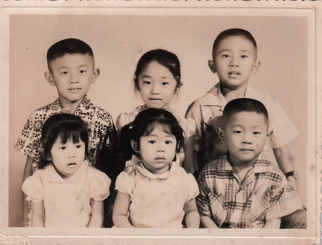 兒時店裡生意忙,曹愛琴(前排中)與手足被寄養在不同家庭,上小學後才一家團圓。(曹愛琴提供)