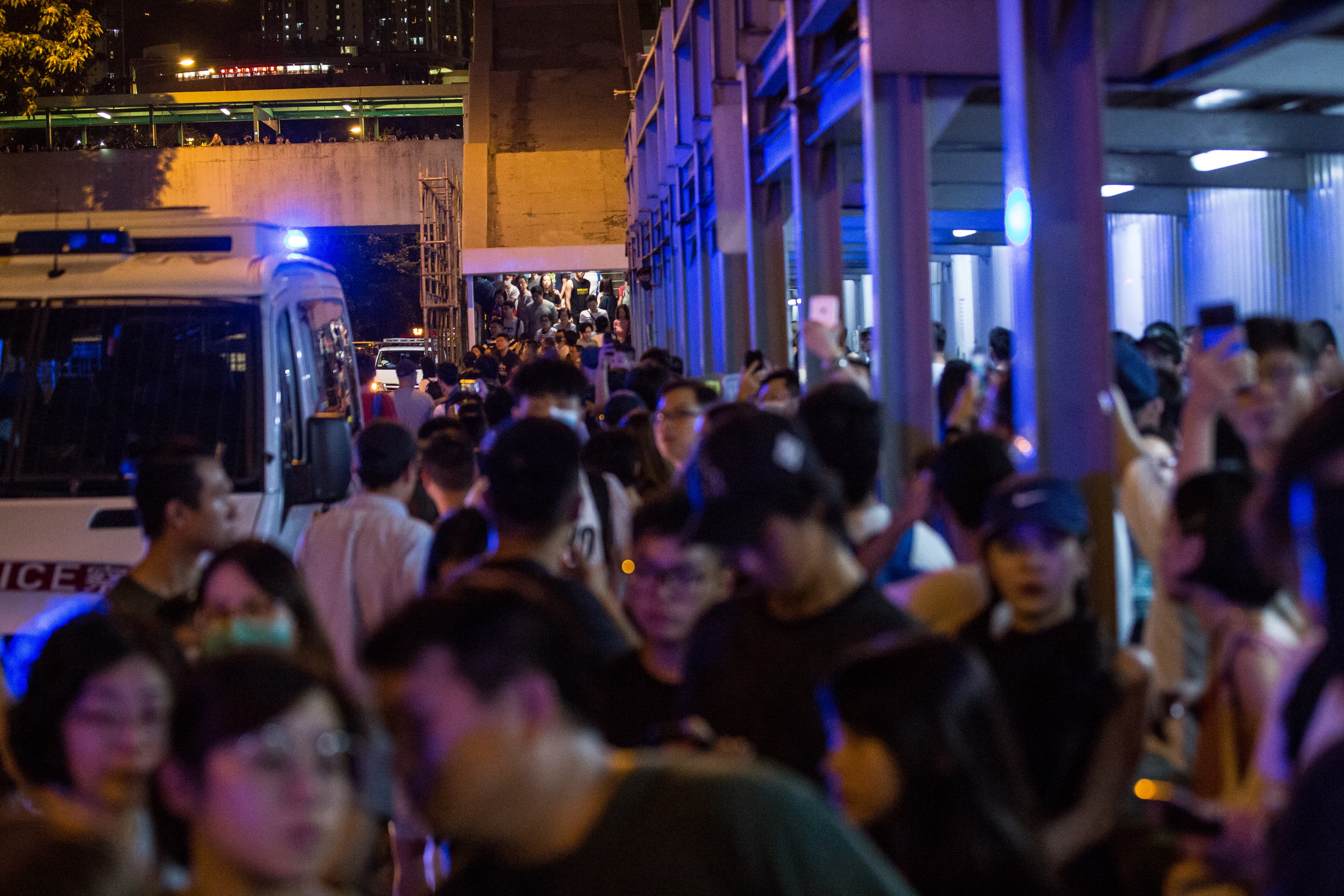 港警任意攔停巴士並盤查市民的行動引發民眾不滿,聚集聲援該巴士上的乘客。