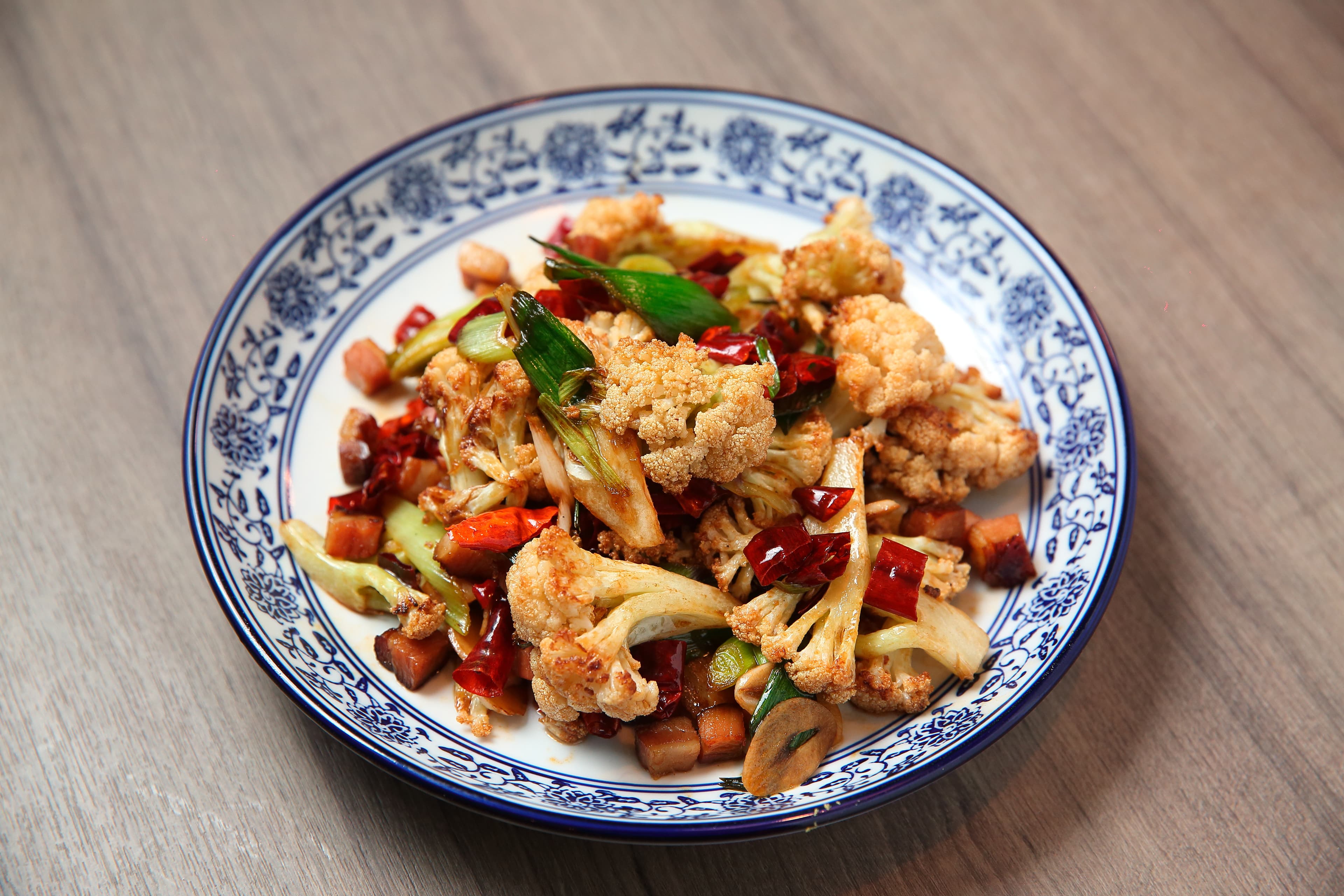湘八老的土家花椰菜，花椰菜過炸，加上湖南臘肉、乾辣椒煸炒，不油膩又鹹香味十足。（260元／份）