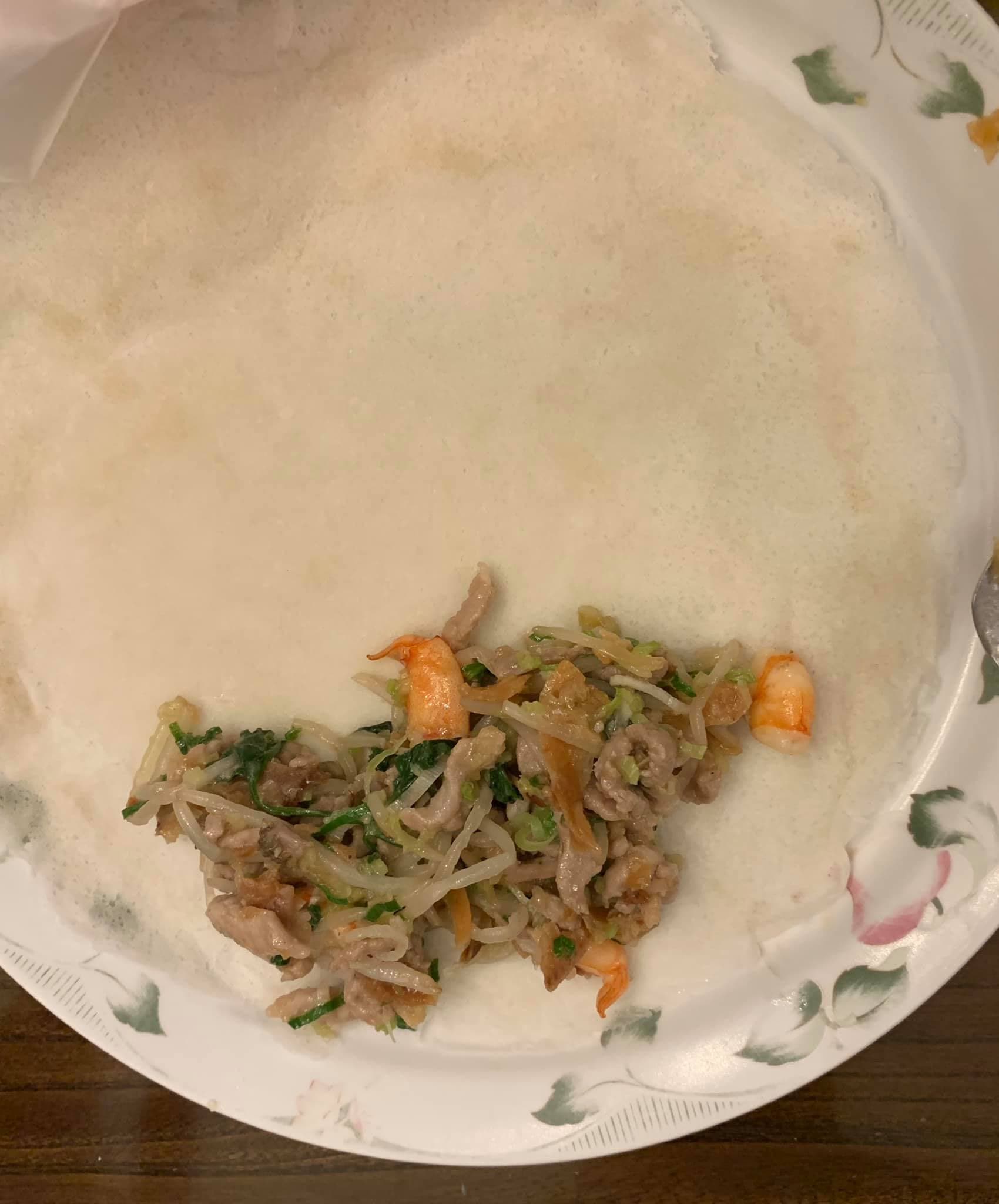將餡料放餅皮一端,壓緊捲起,兩邊折進捲到底,沾麵粉水封口。