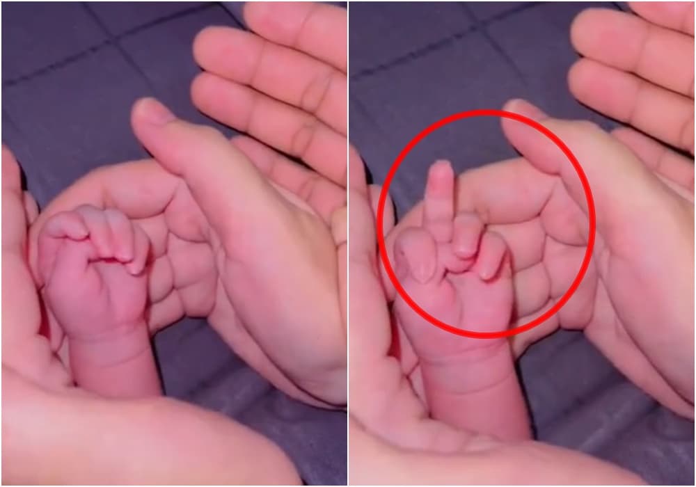 拳的小嬰兒下秒突然比出中指,爸媽瞬間笑翻。(翻攝微博)