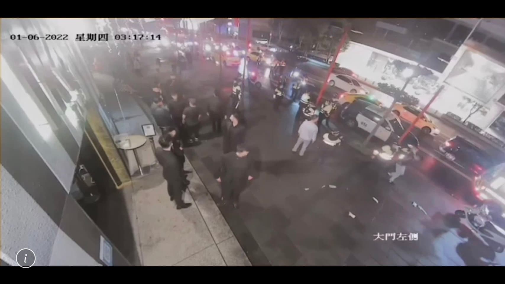 十餘名男子在店外打成一片,夜店報警後也派人在門口安管。(警方提供)