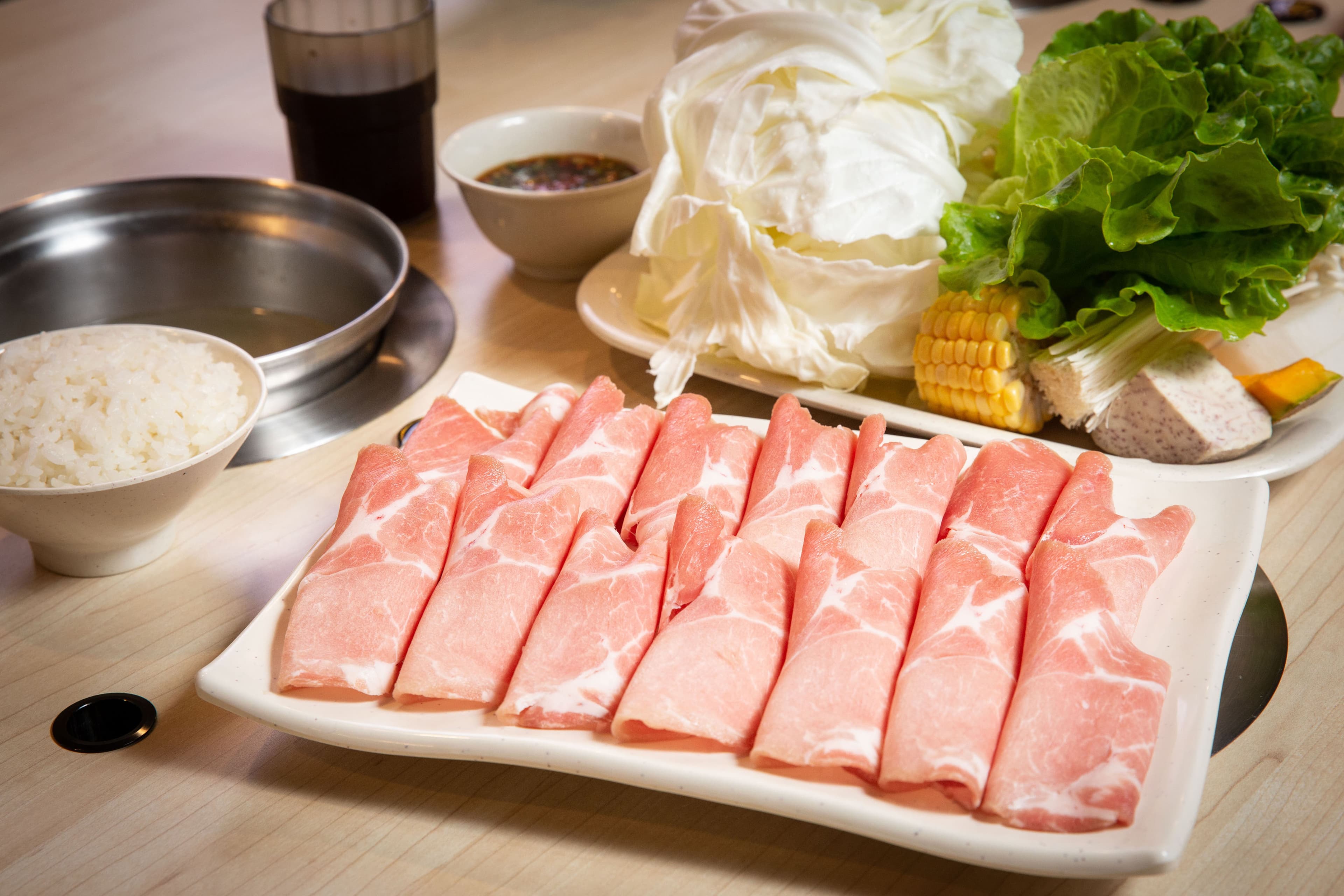 錢都的梅花豬肉鍋套餐,白飯、菜盤、肉盤份量頗足,還可選擇菜多或肉多,希望讓顧客都能吃飽。(269元/份,板橋雙十店)