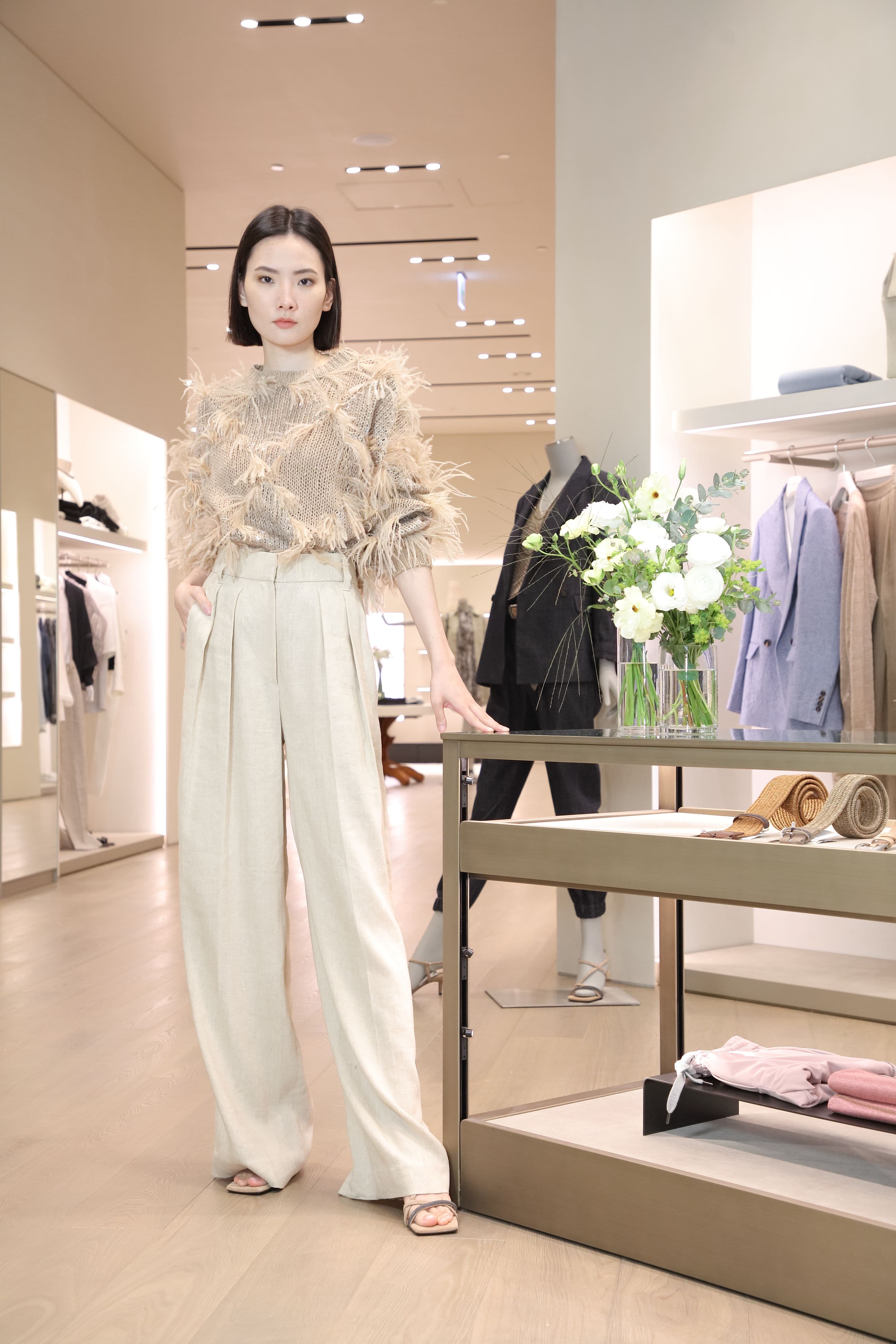 Model蔣蘋展演2022春夏新品：羽毛亮片針織衫NT$187,100、淺卡其色寬版長褲NT$56,100、Monili條帶高跟涼鞋NT$38,700。（藍鐘提供）