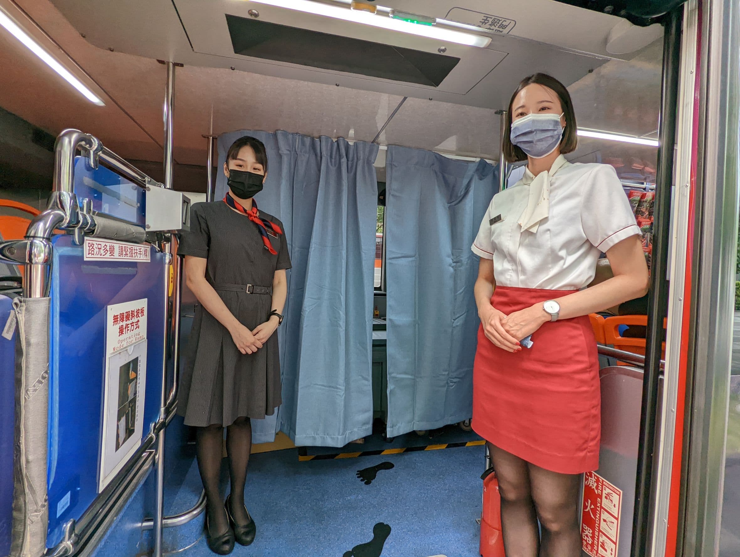 車掌小姐在門口迎接乘客。