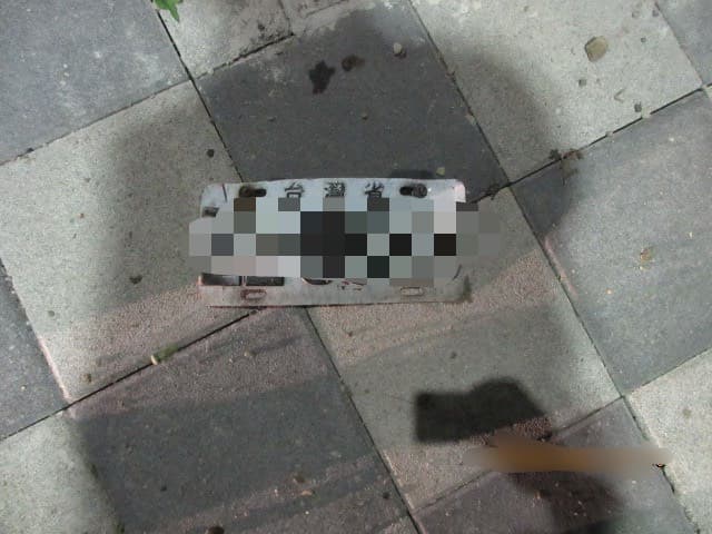 警方在事故現場發現疑似自小客撞擊後掉落的車牌,將循線通知車主到案說明。(警方提供)