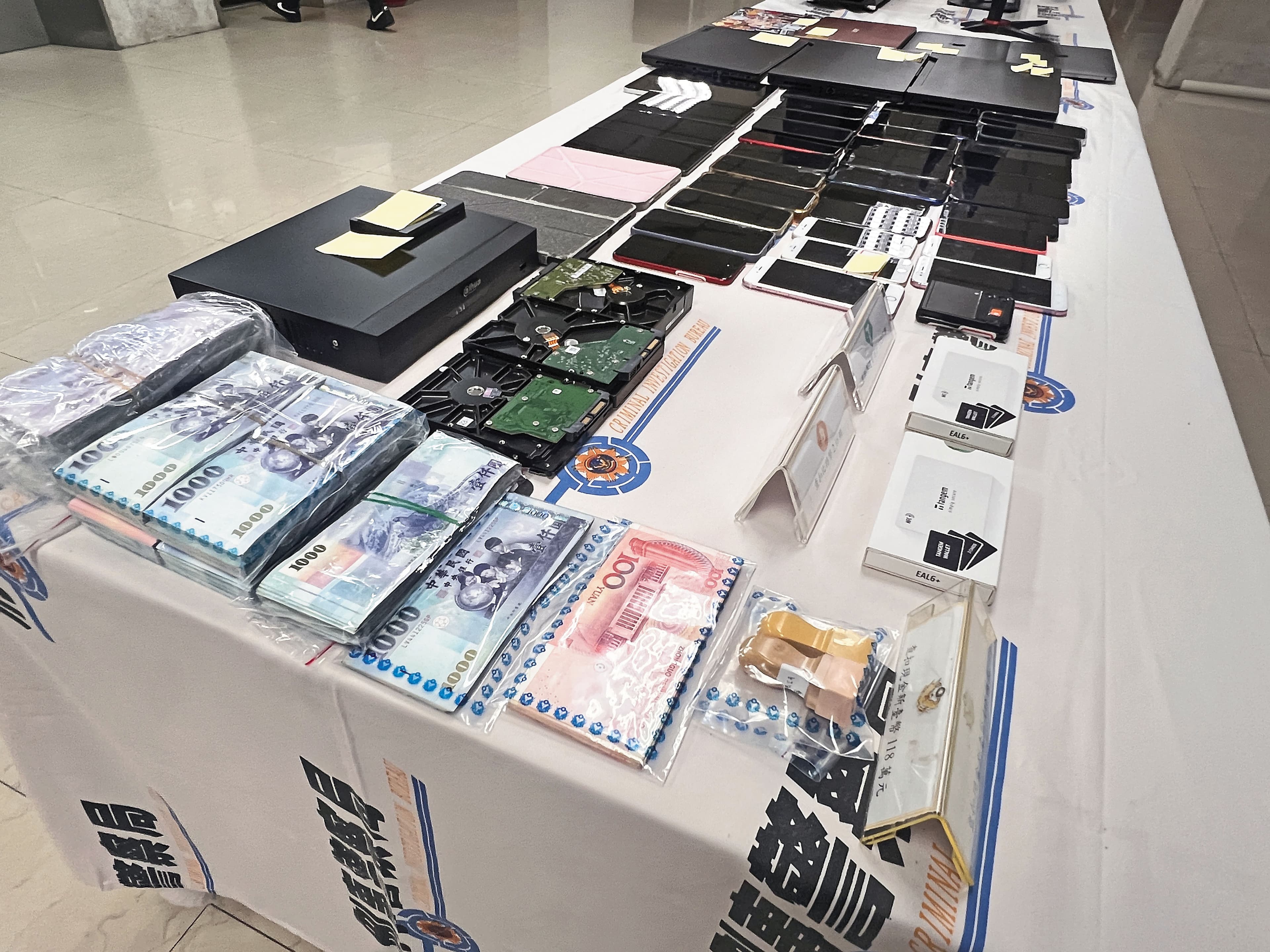 警方在黃鶴樓及共犯的工作室和住處,查扣大批贓款、手機及電腦。(刑事局提供)