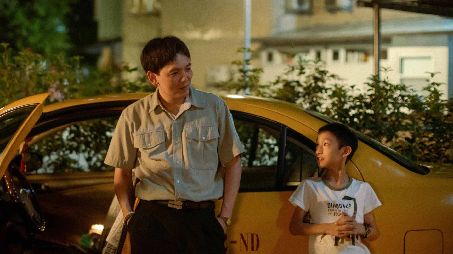 春風(洪瑜鴻)在《我的棋王爺爺》裡扮演謝以樂(右)的計程車司機爸爸。(北影提供)