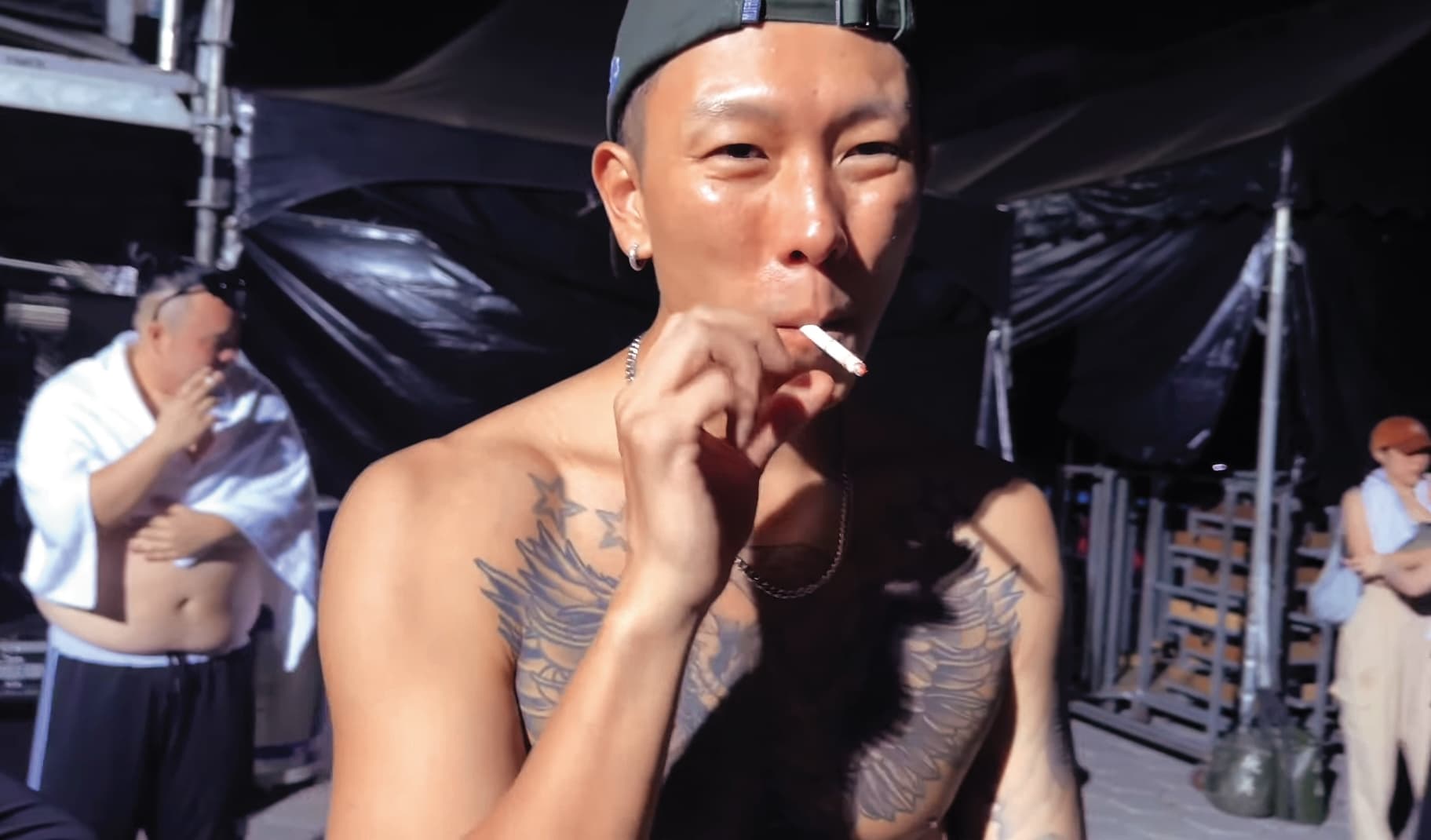 在演出後,瘦子(前)脫掉上衣在後台抽菸抒壓,後方的大淵(後)也在吞雲吐霧。(翻攝自本色音樂臉書)