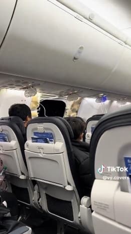 這架飛機在空中機艙整片窗戶脫落,天花板上掛著掉落的氧氣面罩。(翻攝自X)