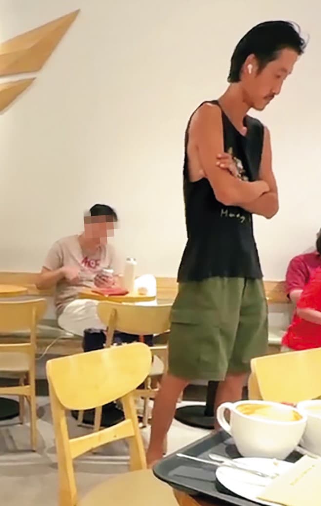 唐治平在咖啡店走來走去,不時站在別人桌旁發怔。(讀者提供)