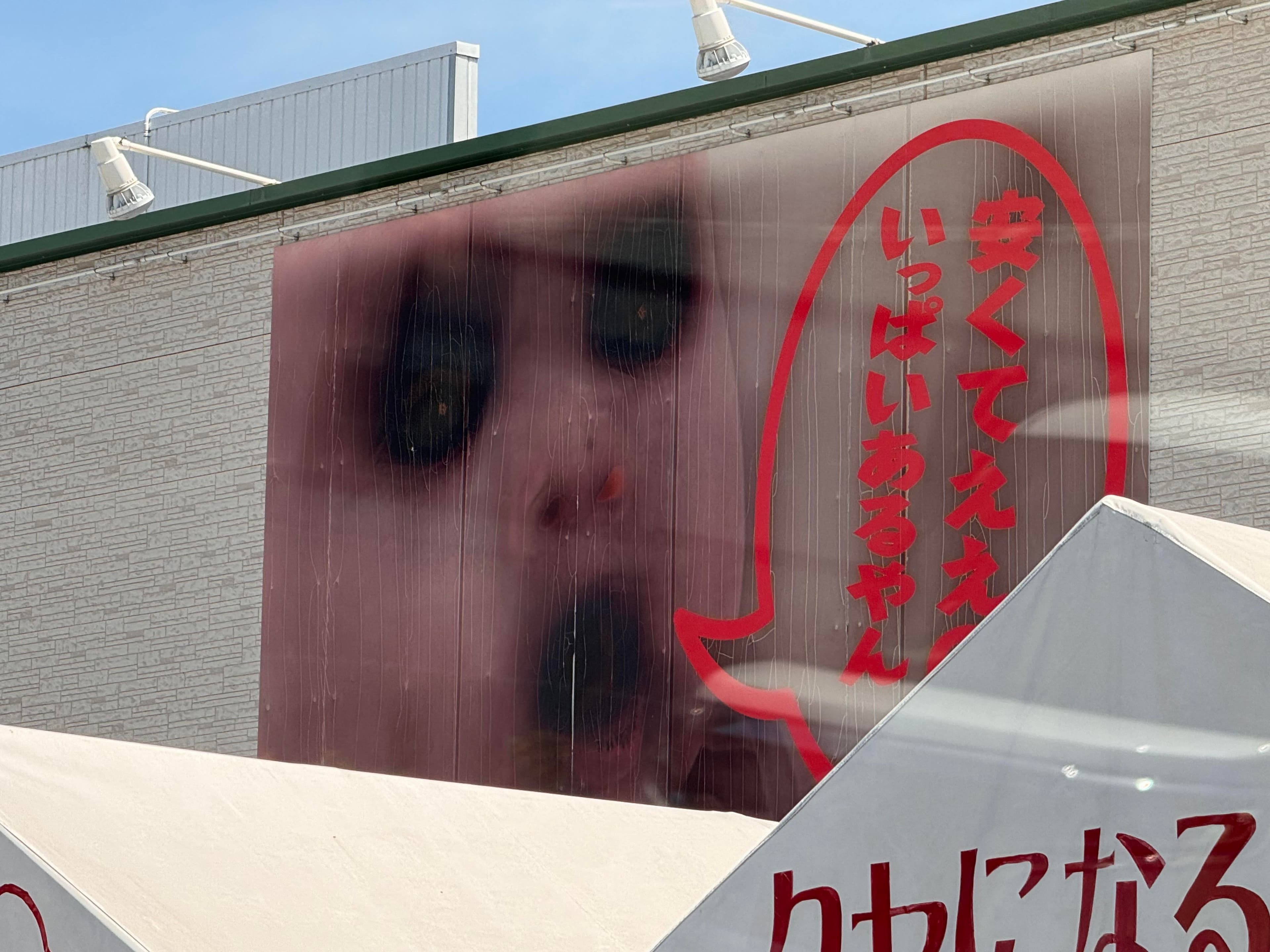 「はんがい」商店寶寶招牌因熱浪融化墨水,轉變成鬼娃風格。(翻攝X@lcqpi)