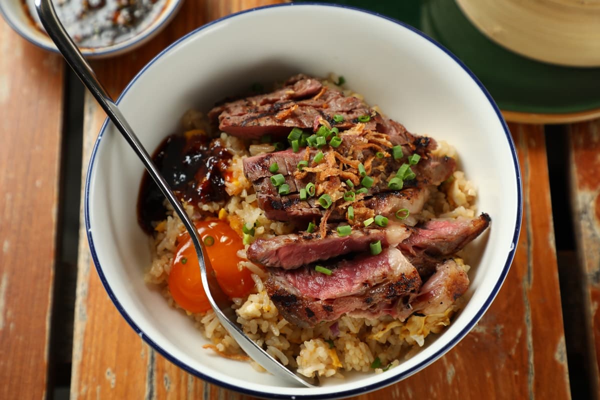 「Khao Pad Nuea Yang」是由大蒜炒飯、烤牛肉、半熟蛋組合成的邪惡美味。（360泰銖／份，約NT$317）