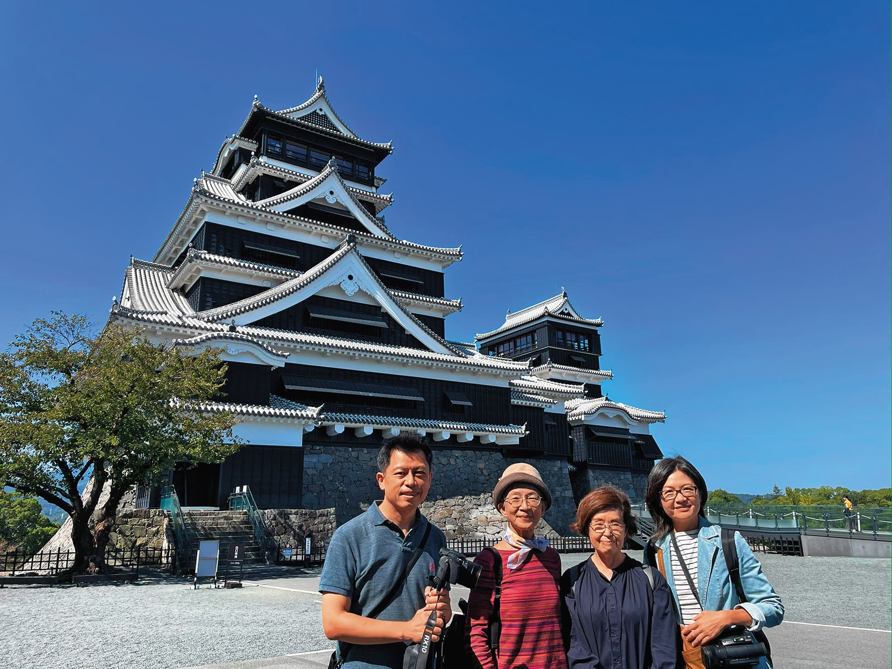 黃銘正(左一)和連楨惠(右一)赴日本拍攝,與湯聰模的女兒湯雅清(左二)、表妹水上裕子(右二)在熊本城前合影。(希望行銷提供)