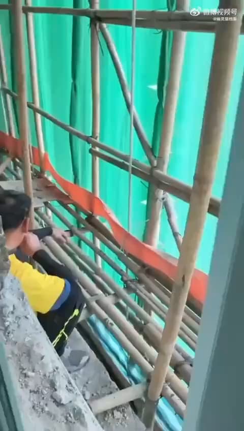 疑似工人在鷹架(竹棚)抽菸畫面瘋傳。(翻攝微博)