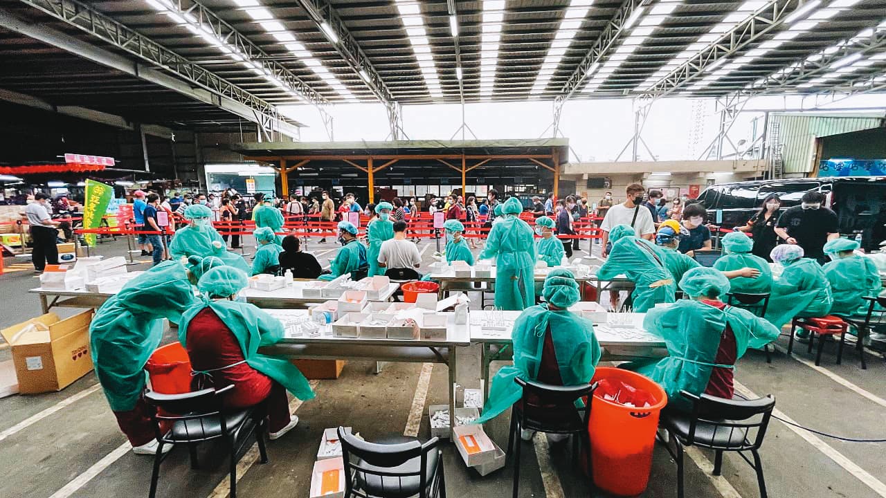 公衛專家指出,控制小群聚感染擴大成社區流行,關鍵仍在篩檢。圖為北市環南市場篩檢畫面。(亞東醫院提供)