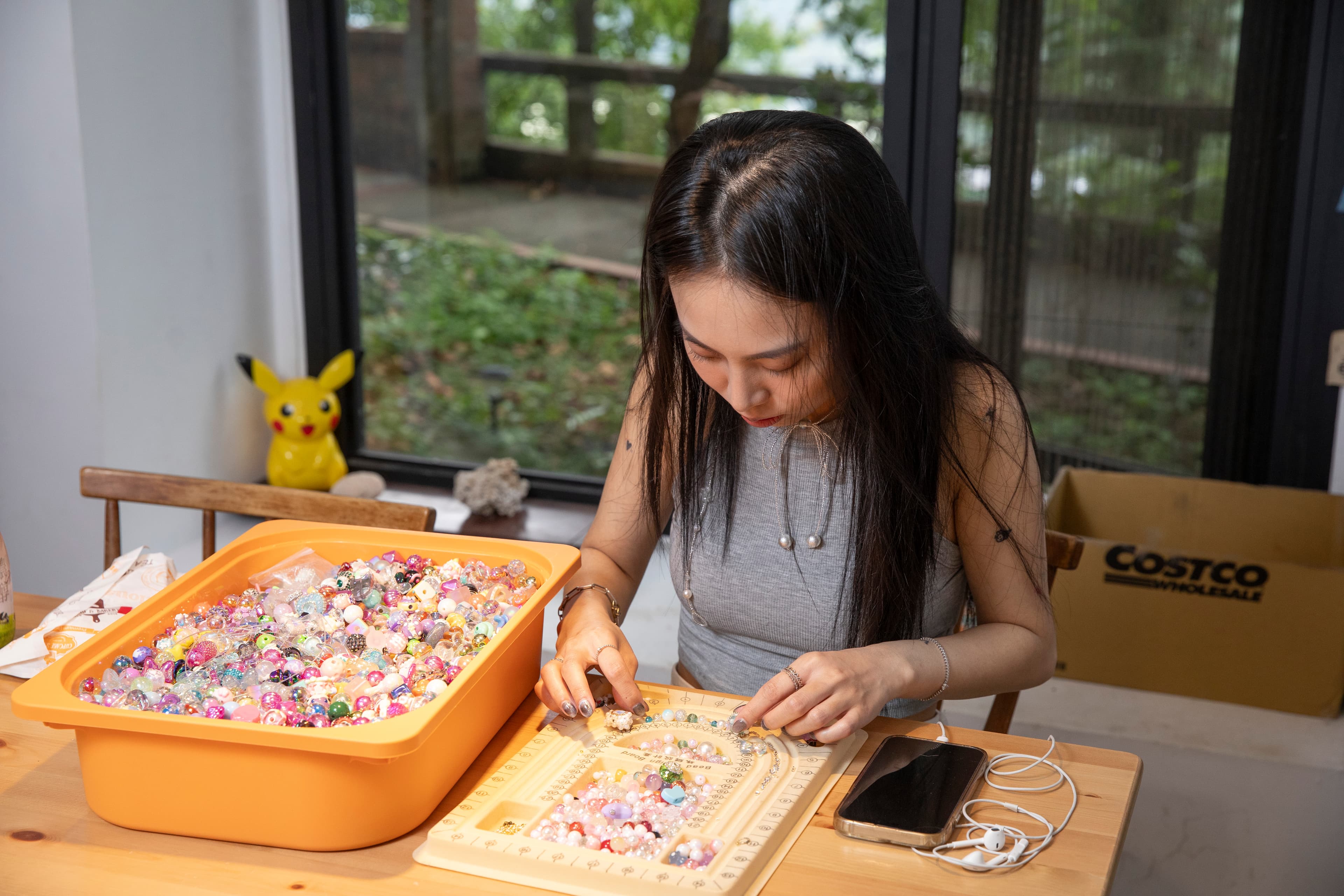 陳瑾緗專注地製作串珠手鍊,她每天可做10條,每條的顏色、細節都不一樣。